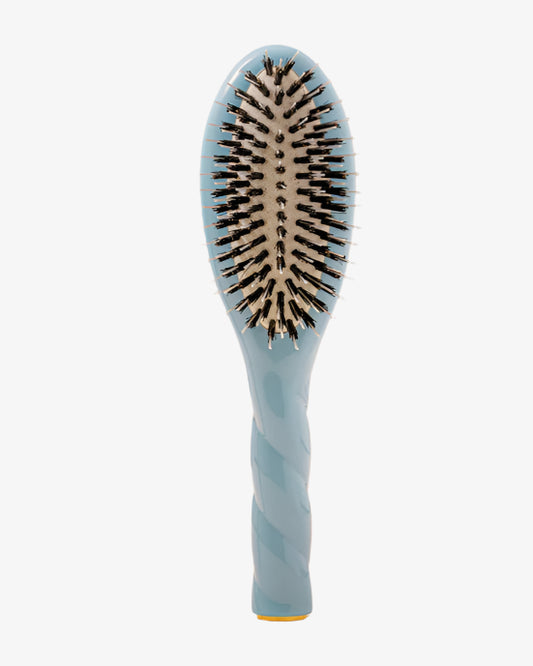 Blue hairbrush with black bristles on a white background