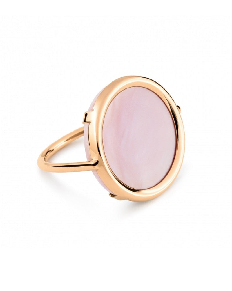 A rose gold-colored ring with a large central pink stone, surrounded by a thin gold band.